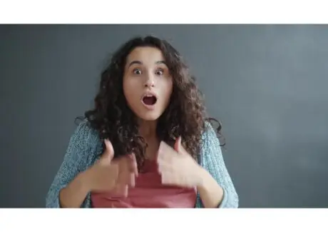 Woman with a startled, wide-eyed reaction and open mouth