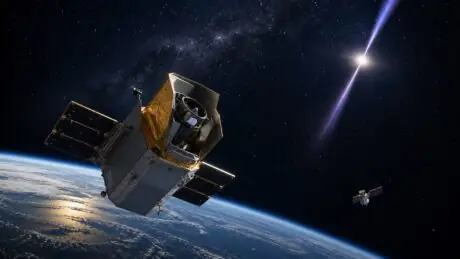 Original illustration of a Swift-like space observatory watching a distant gamma-ray burst above Earth while a small servicing spacecraft remains separate nearby.