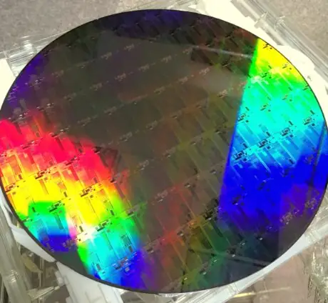 Close-up of a reflective 300-millimeter silicon photonics wafer used as an illustrative image for quantum manufacturing