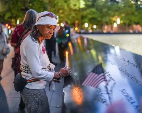 Visitor holding a candle at the National September 11 Memorial