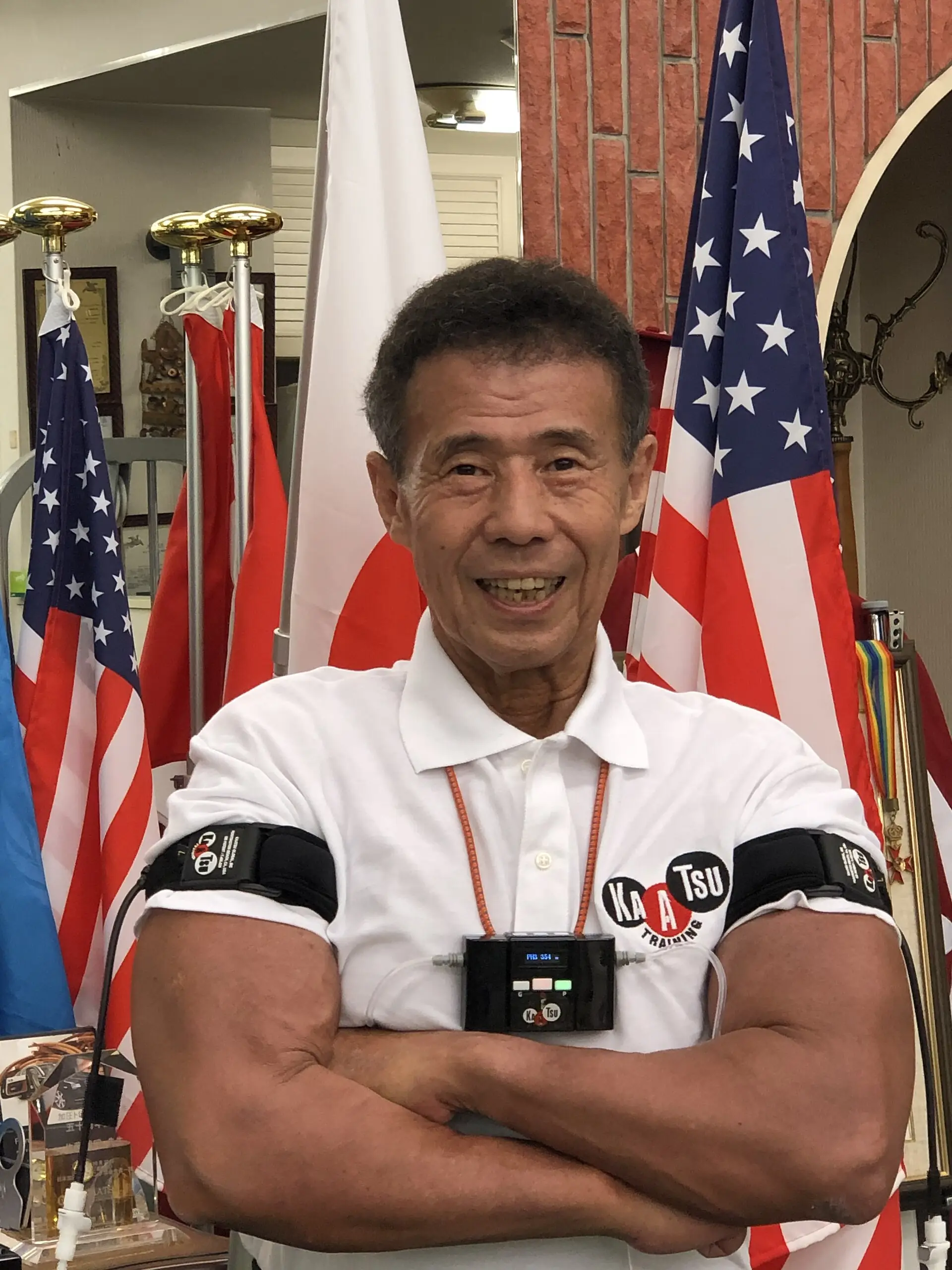 Dr Yoshiaki Sato demonstrating blood-flow-restriction training bands