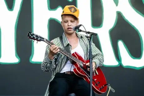 Musician performing with an electric guitar on stage