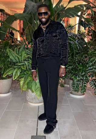 Igho Ubiribo wearing sunglasses and a black outfit