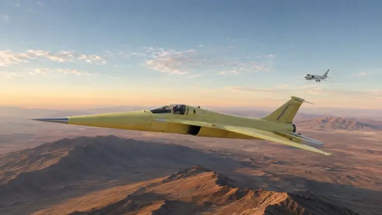 Yellow X-59 quiet-supersonic research aircraft flying above California’s Mojave Desert with a chase plane in the distance