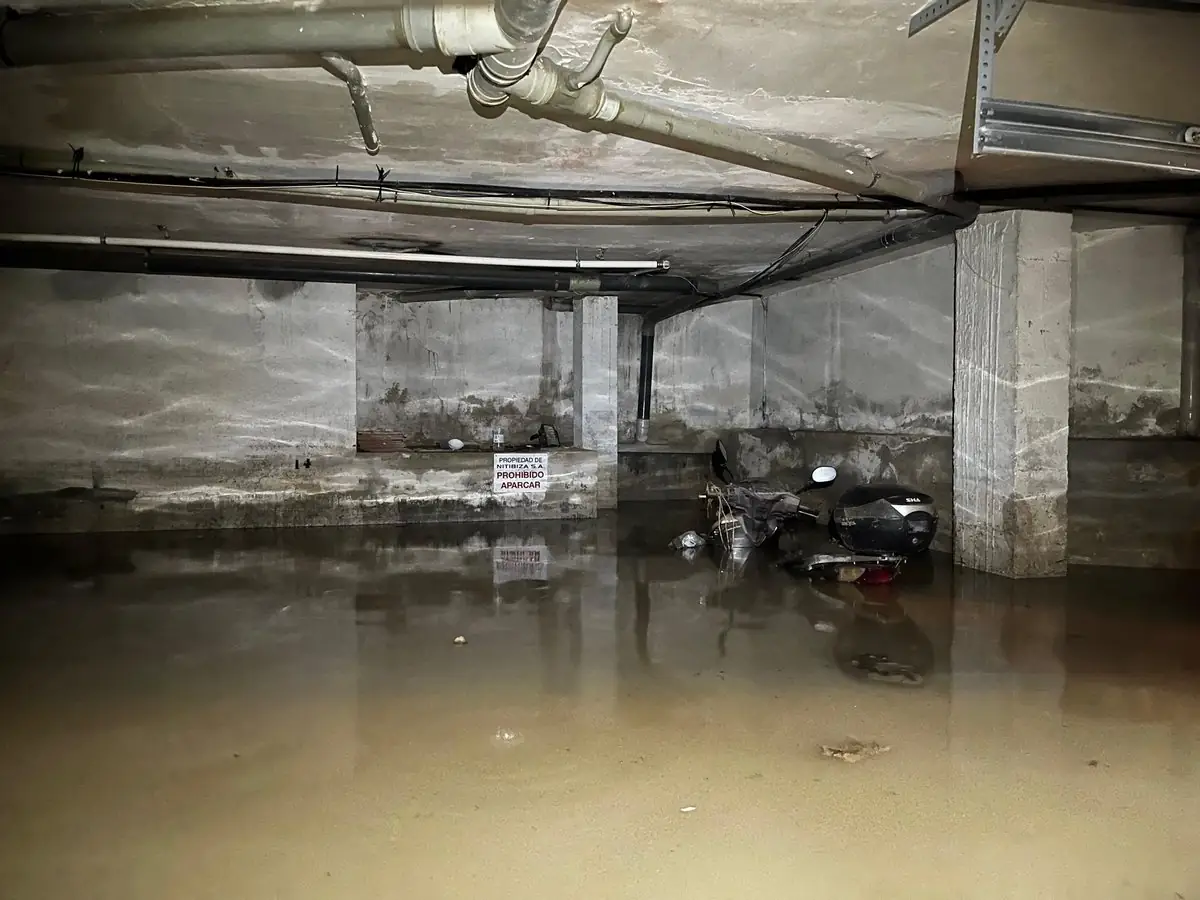 Floodwater around a motor scooter inside an Ibiza garage during DANA Adam